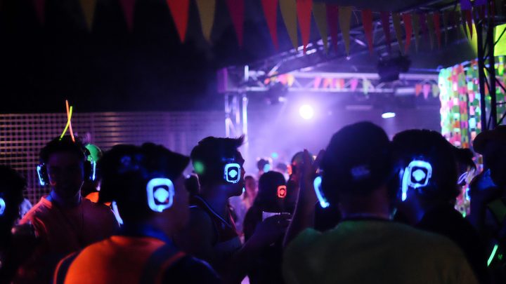 students dancing at the silent disco with colourful headphones on